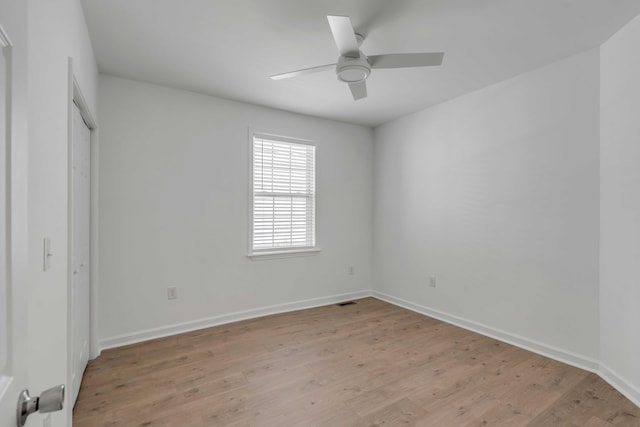 unfurnished bedroom with ceiling fan, light wood-type flooring, and a closet