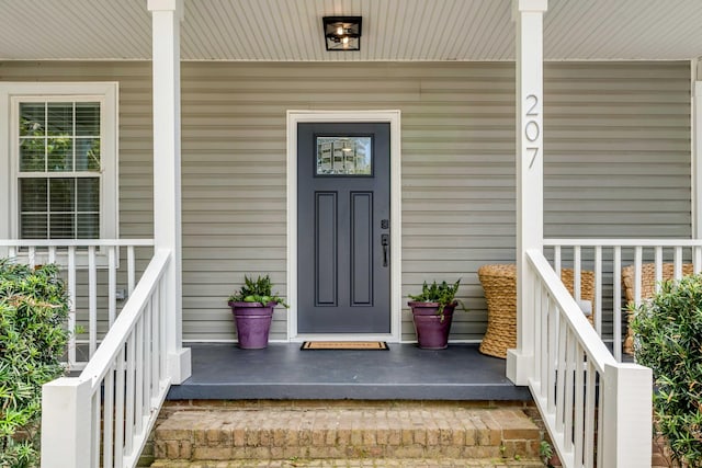 entrance to property featuring a porch