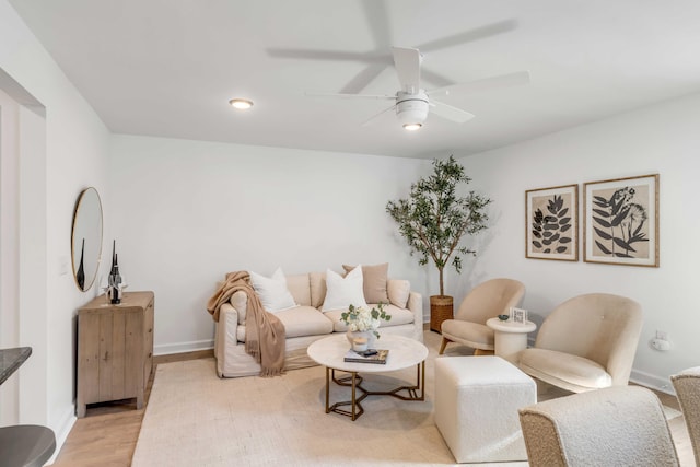 living room featuring light hardwood / wood-style floors and ceiling fan