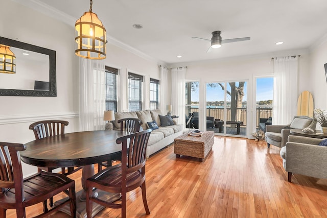 dining space featuring light wood-style flooring, recessed lighting, ceiling fan with notable chandelier, and ornamental molding