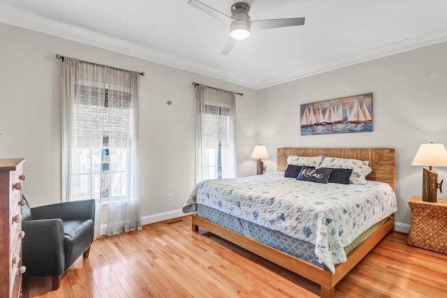 bedroom with ceiling fan, baseboards, hardwood / wood-style floors, and crown molding