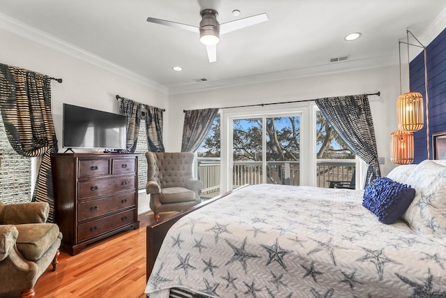 bedroom featuring visible vents, wood finished floors, ornamental molding, and access to outside