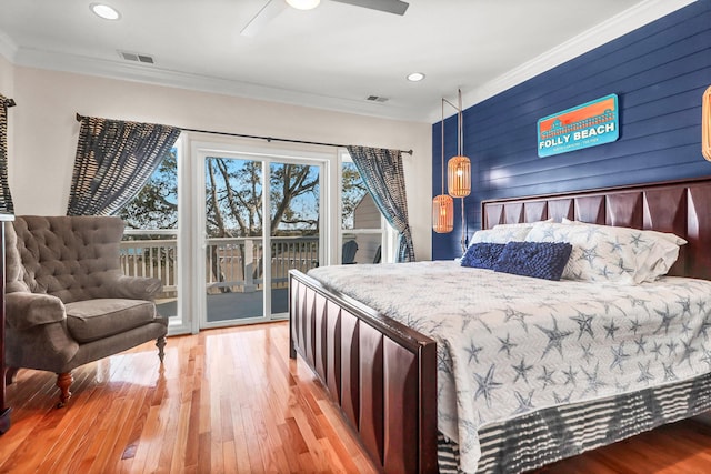 bedroom with visible vents, light wood-style floors, access to exterior, and ornamental molding