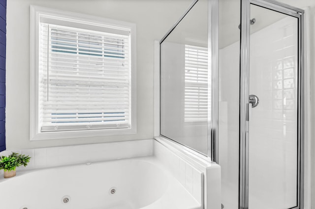 full bath featuring a stall shower and a whirlpool tub