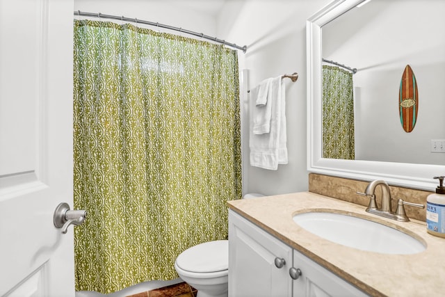 full bathroom with vanity, a shower with shower curtain, and toilet