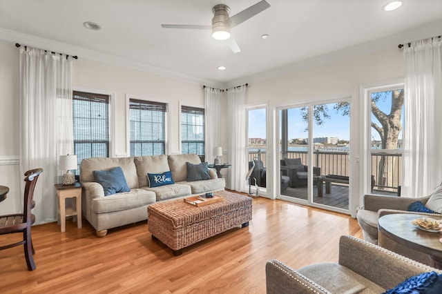 living area with recessed lighting, crown molding, light wood-type flooring, and ceiling fan