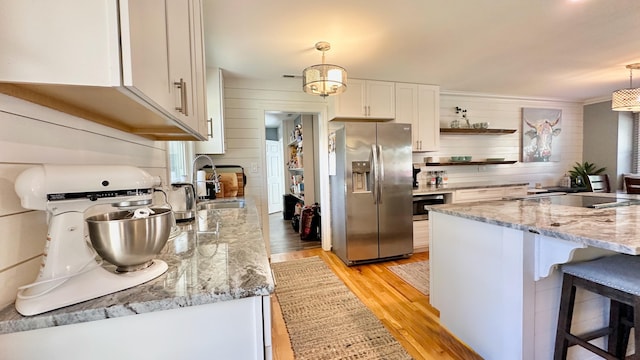 2636 Elissa Dr, Charleston, SC 29414 - kitchen with stainless steel refrigerator with ice dispenser, open shelves, light wood-style flooring, a sink, and white cabinetry