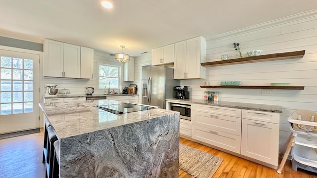 2636 Elissa Dr, Charleston, SC 29414 - kitchen with appliances with stainless steel finishes, open shelves, white cabinets, a kitchen island, and crown molding