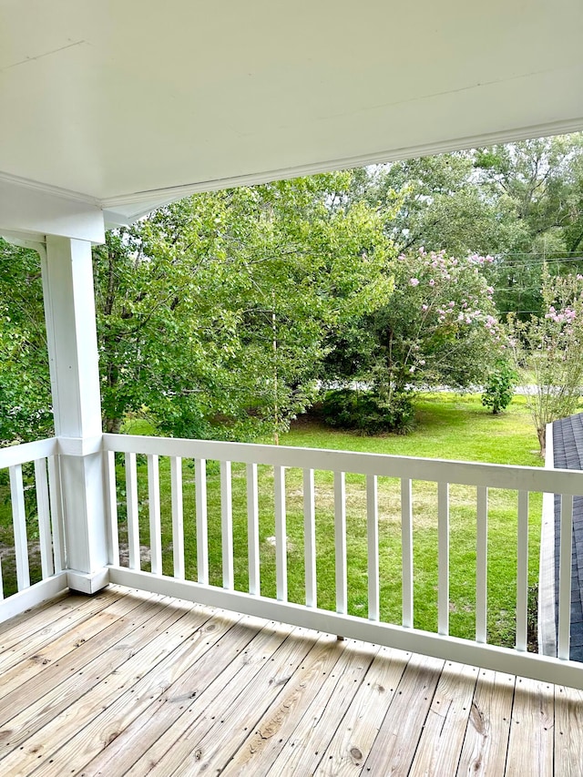 wooden terrace with a lawn