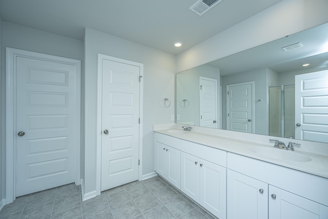 bathroom featuring tile patterned flooring and double sink vanity