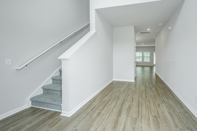 staircase featuring light wood-type flooring