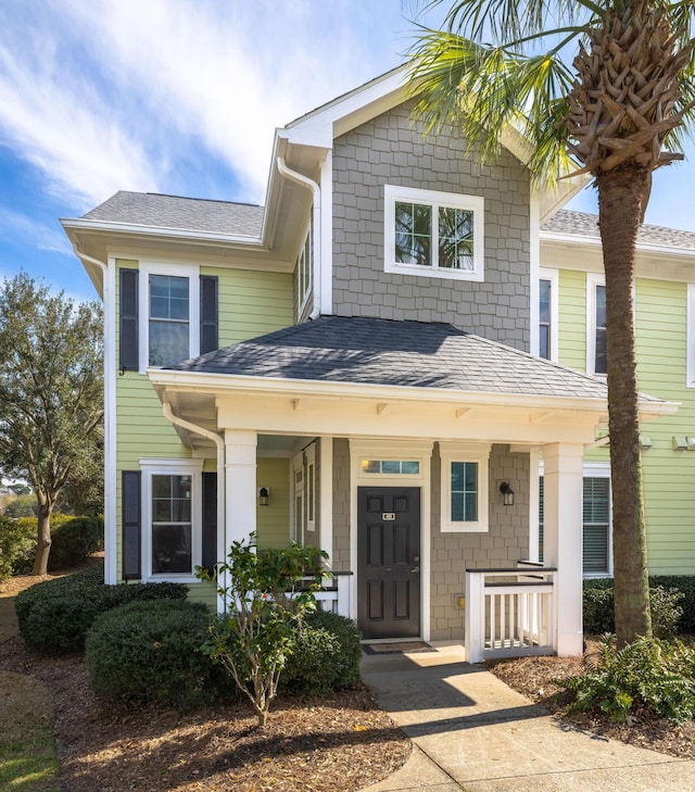 view of front of home with a porch and roof with shingles