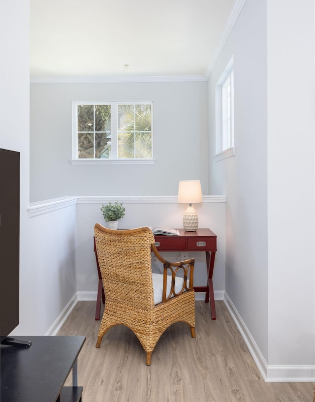 sitting room with crown molding, baseboards, and wood finished floors