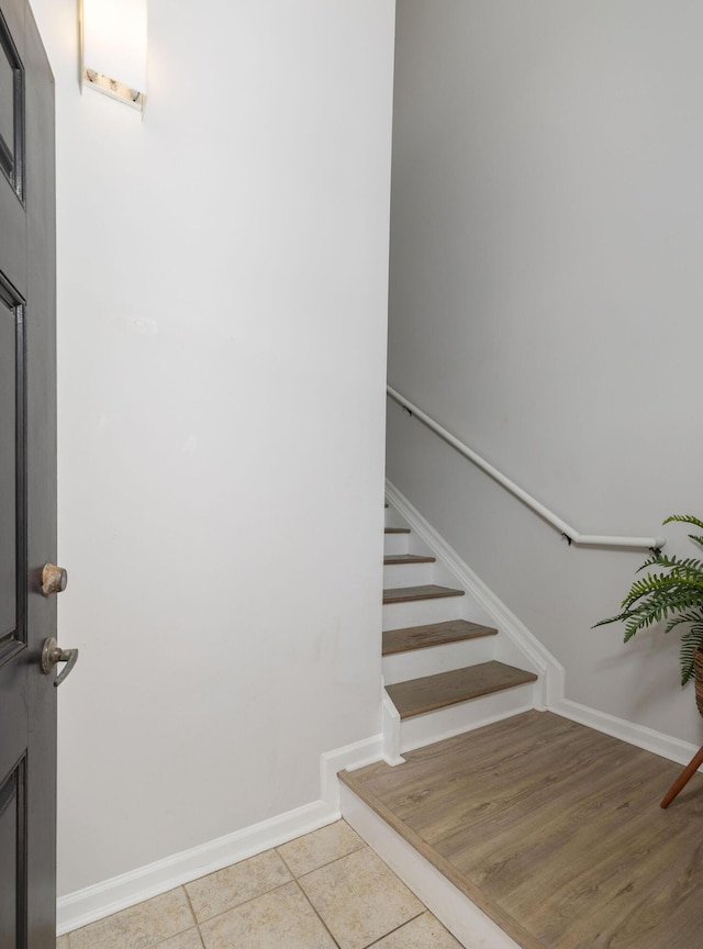 staircase with tile patterned flooring and baseboards