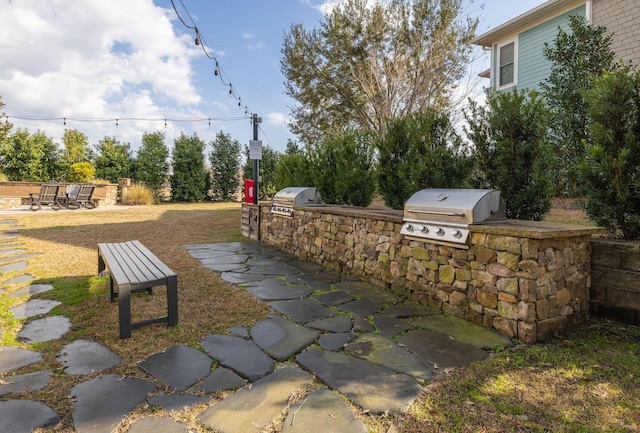 view of patio with a grill and an outdoor kitchen