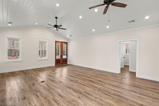 unfurnished living room with vaulted ceiling, french doors, plenty of natural light, and visible vents