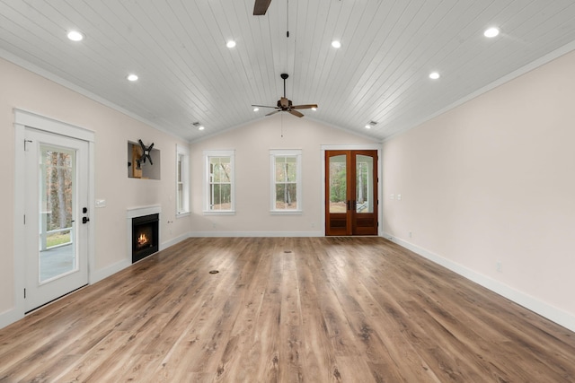 unfurnished living room featuring wood ceiling, a lit fireplace, vaulted ceiling, french doors, and light wood-type flooring