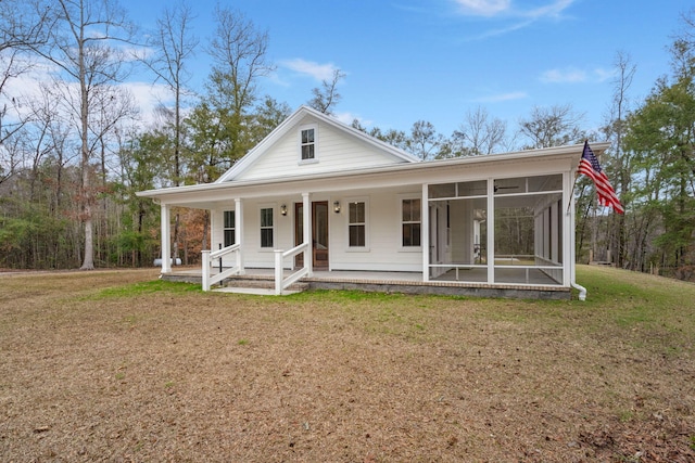 country-style home with a sunroom, a front lawn, and covered porch