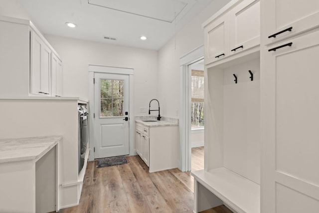 mudroom with attic access, visible vents, light wood-type flooring, a sink, and recessed lighting