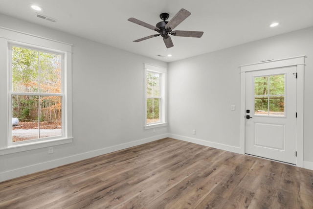 empty room with baseboards, visible vents, ceiling fan, wood finished floors, and recessed lighting