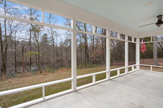 unfurnished sunroom featuring a ceiling fan