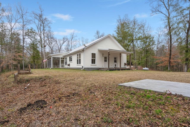 view of front of house with a porch, a sunroom, and a front lawn