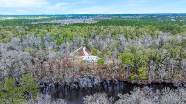 birds eye view of property featuring a water view and a forest view