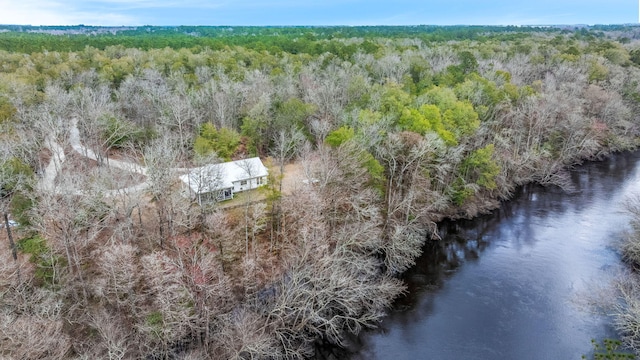 drone / aerial view with a water view and a wooded view