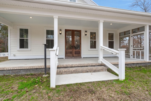 entrance to property featuring covered porch and french doors