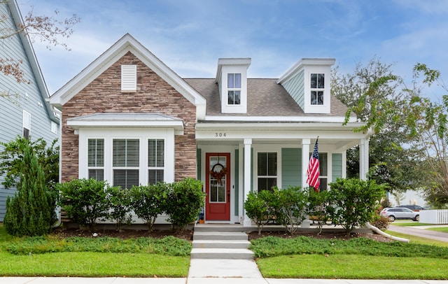 view of front facade with a front yard and a porch