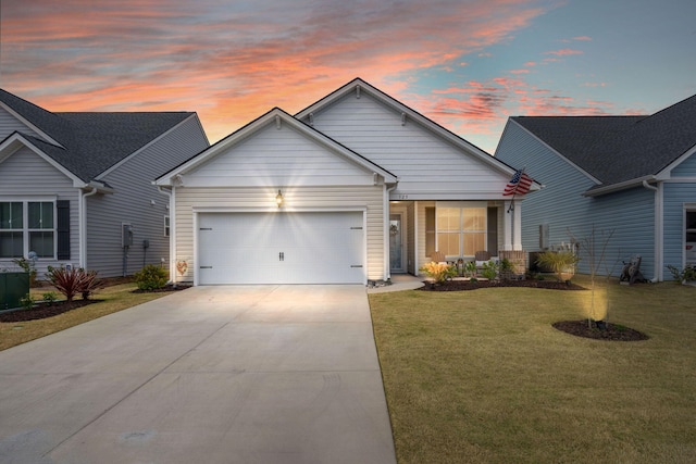 view of front of house with concrete driveway, a lawn, and an attached garage