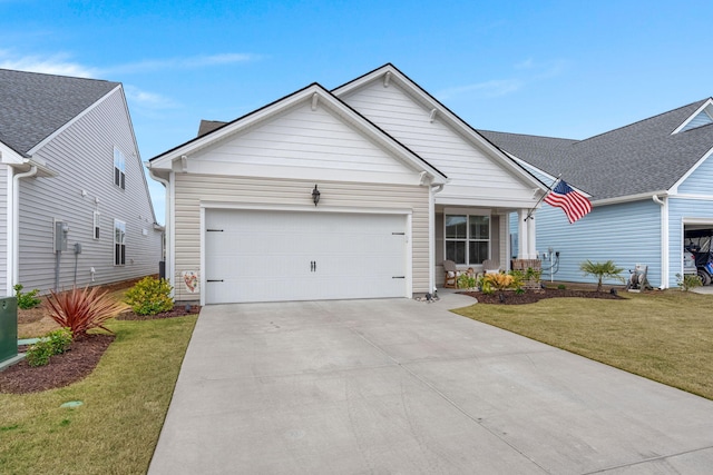 view of front of property with an attached garage, a front lawn, and concrete driveway