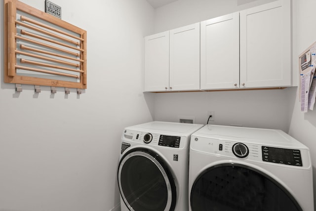 laundry room featuring cabinet space, washer and clothes dryer, and radiator heating unit