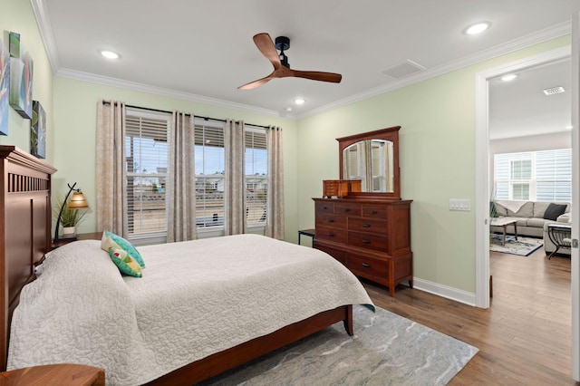 bedroom with recessed lighting, wood finished floors, visible vents, baseboards, and crown molding