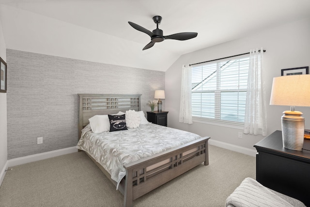 bedroom with wallpapered walls, baseboards, lofted ceiling, ceiling fan, and carpet