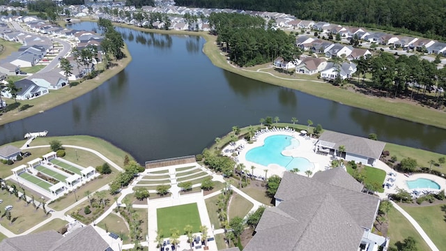 birds eye view of property featuring a water view and a residential view