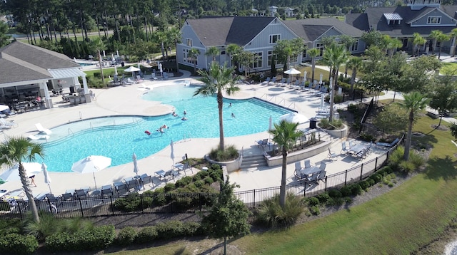 community pool featuring a patio and fence