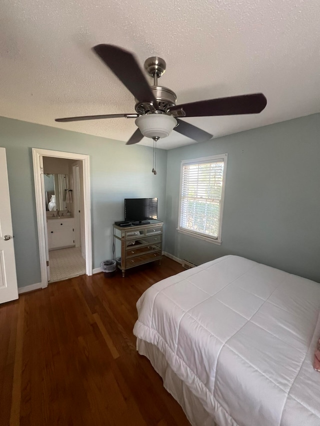 bedroom featuring dark hardwood / wood-style floors, a textured ceiling, and ceiling fan