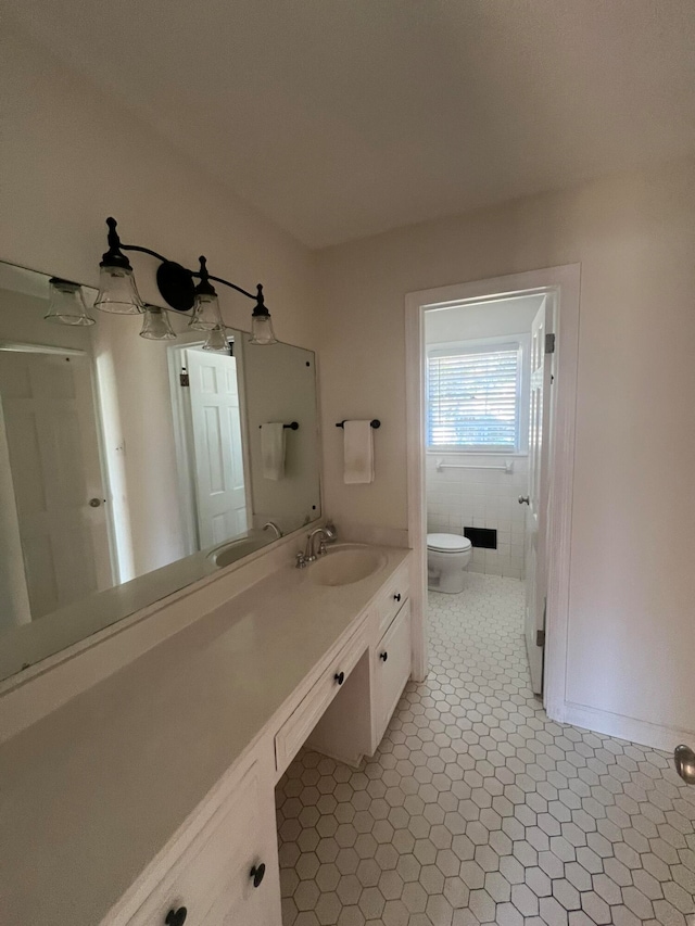 bathroom featuring toilet, vanity, and tile patterned floors