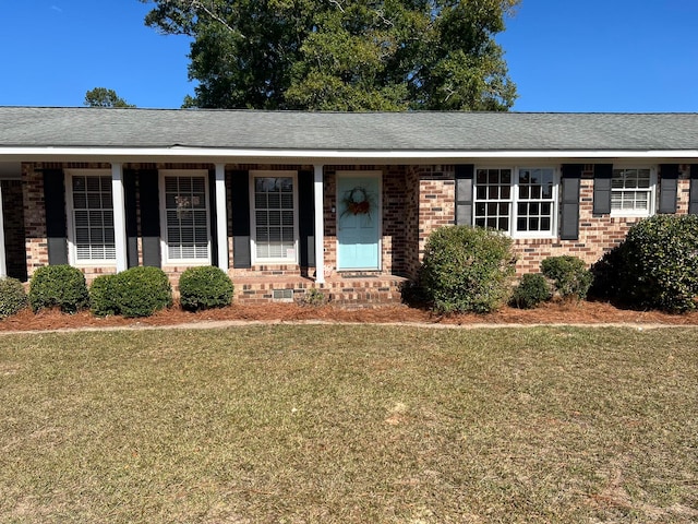 single story home featuring a front lawn and a porch