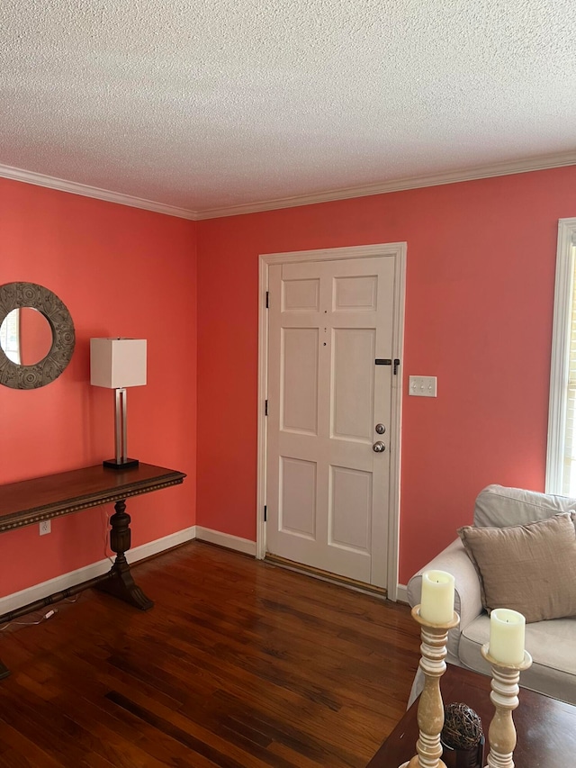 foyer entrance with crown molding, dark hardwood / wood-style floors, and a textured ceiling