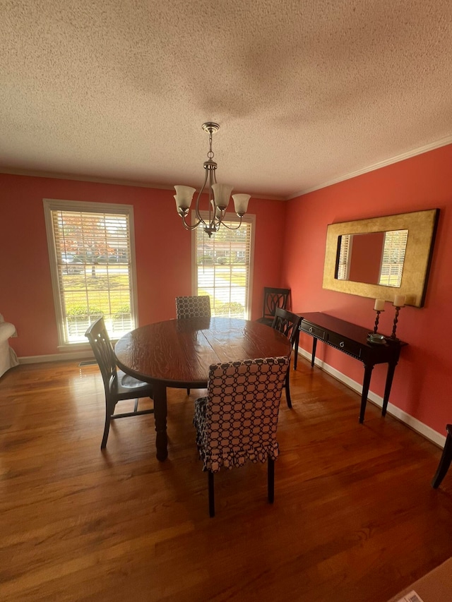 dining space featuring a wealth of natural light, hardwood / wood-style flooring, and an inviting chandelier