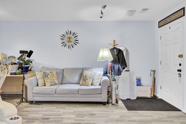 living room with wood finished floors and visible vents