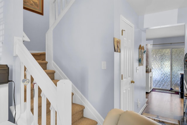 stairway featuring baseboards