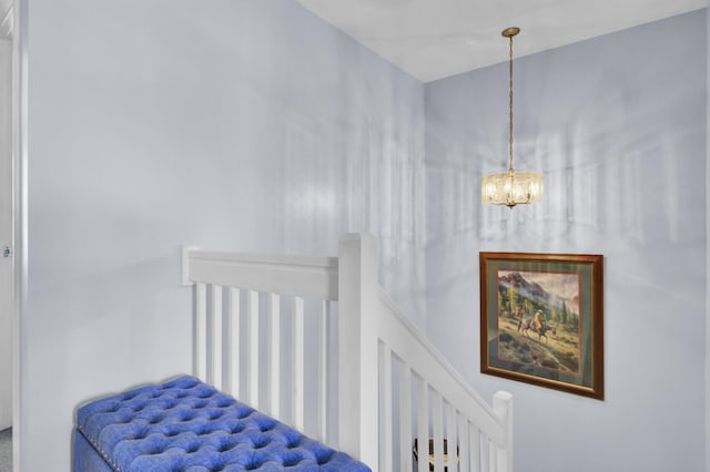 staircase featuring an inviting chandelier