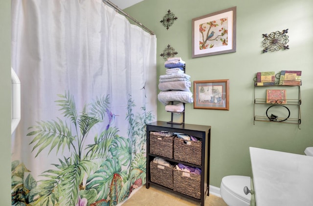 full bath with tile patterned floors, toilet, and a shower with shower curtain