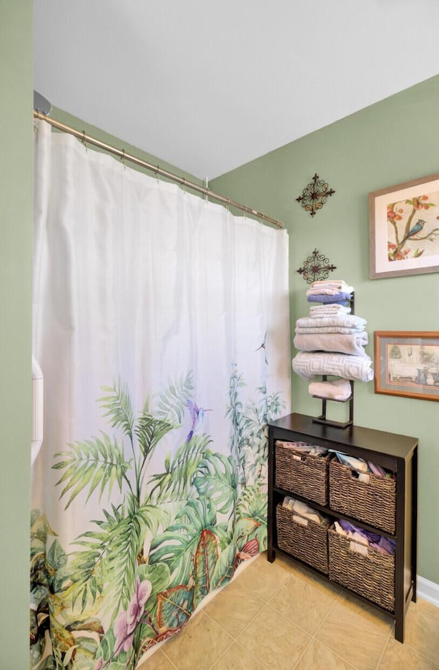 full bathroom featuring tile patterned flooring and curtained shower