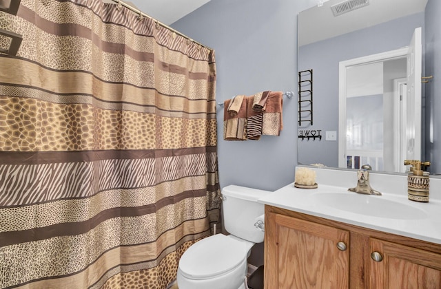 bathroom featuring visible vents, toilet, vanity, and a shower with shower curtain