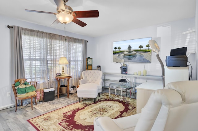 living area featuring ceiling fan and wood finished floors