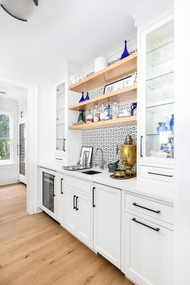 202 Bank St, Mount Pleasant, SC 29464 - indoor wet bar with light wood finished floors, beverage cooler, and crown molding